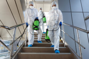 people wearing protective suits disinfecting stair 9YUZJS5 e1590675126802