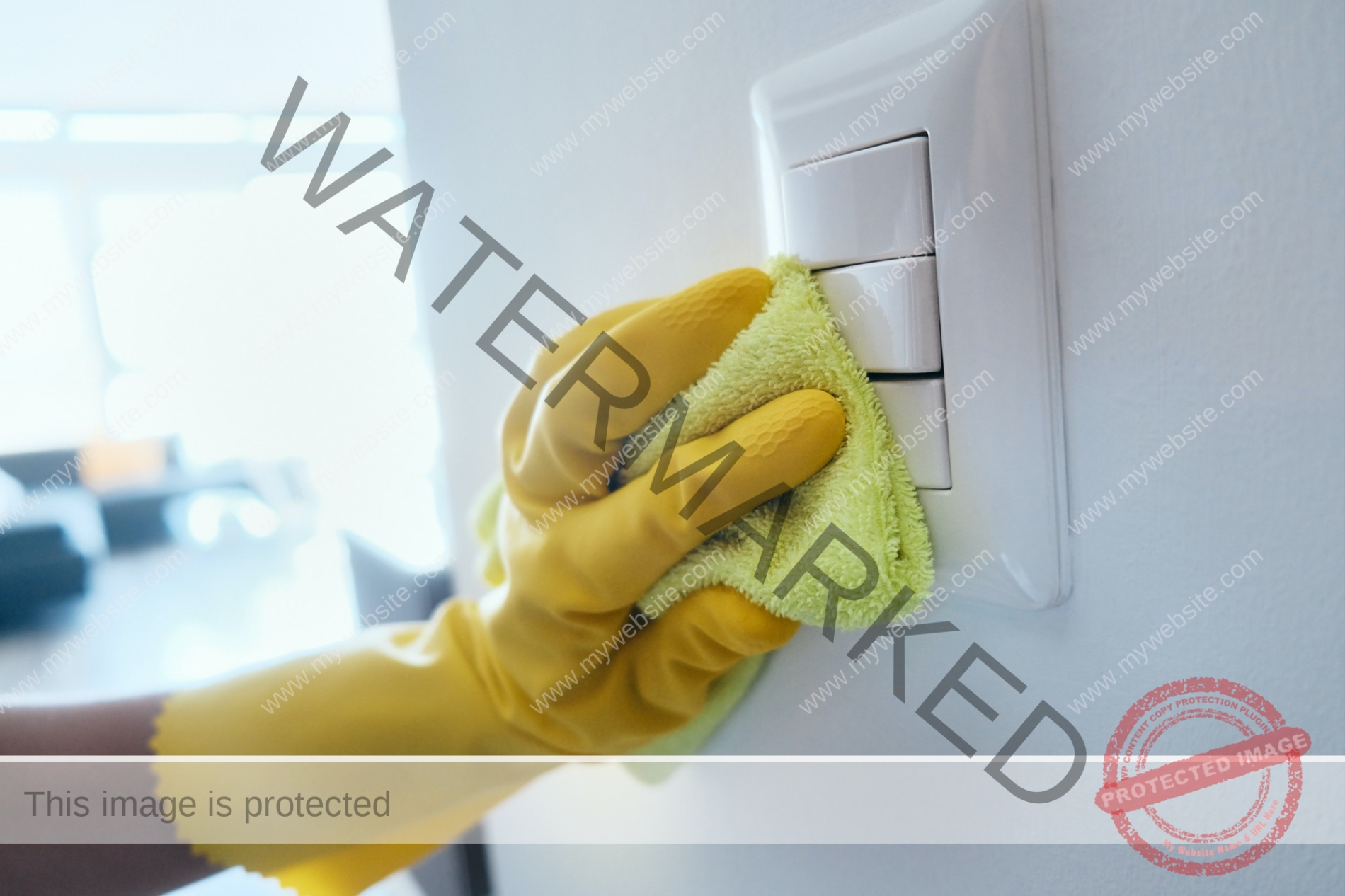 person cleaning and disinfecting electric switches