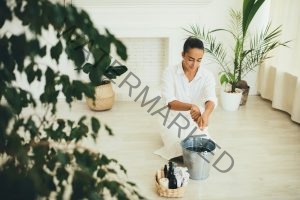 Woman washing floor using natural wooden eco friendly brush and fabric rag. Zero waste cleaning.